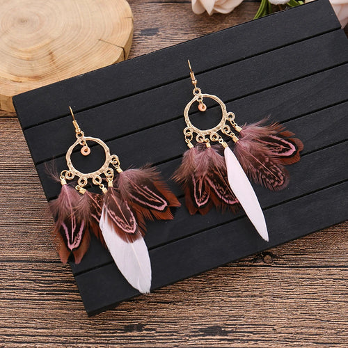 Feather dangle earrings styled for boho western coastal cowgirl outfits