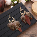Feather dangle earrings styled for boho western coastal cowgirl outfits
