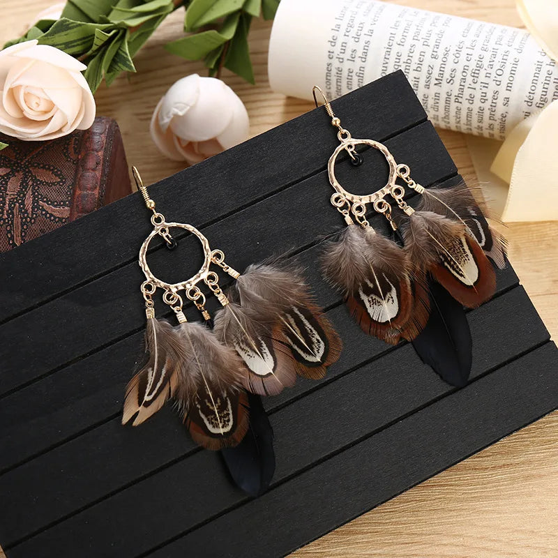 Feather dangle earrings styled for boho western coastal cowgirl outfits