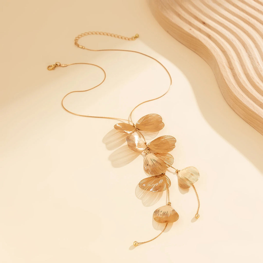 Gold shell design lariat necklace styled for coastal cowgirl beach outfits