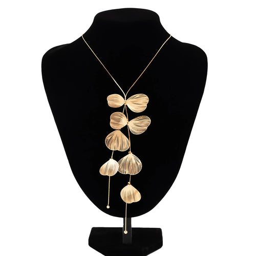 Gold shell design lariat necklace styled for coastal cowgirl beach outfits